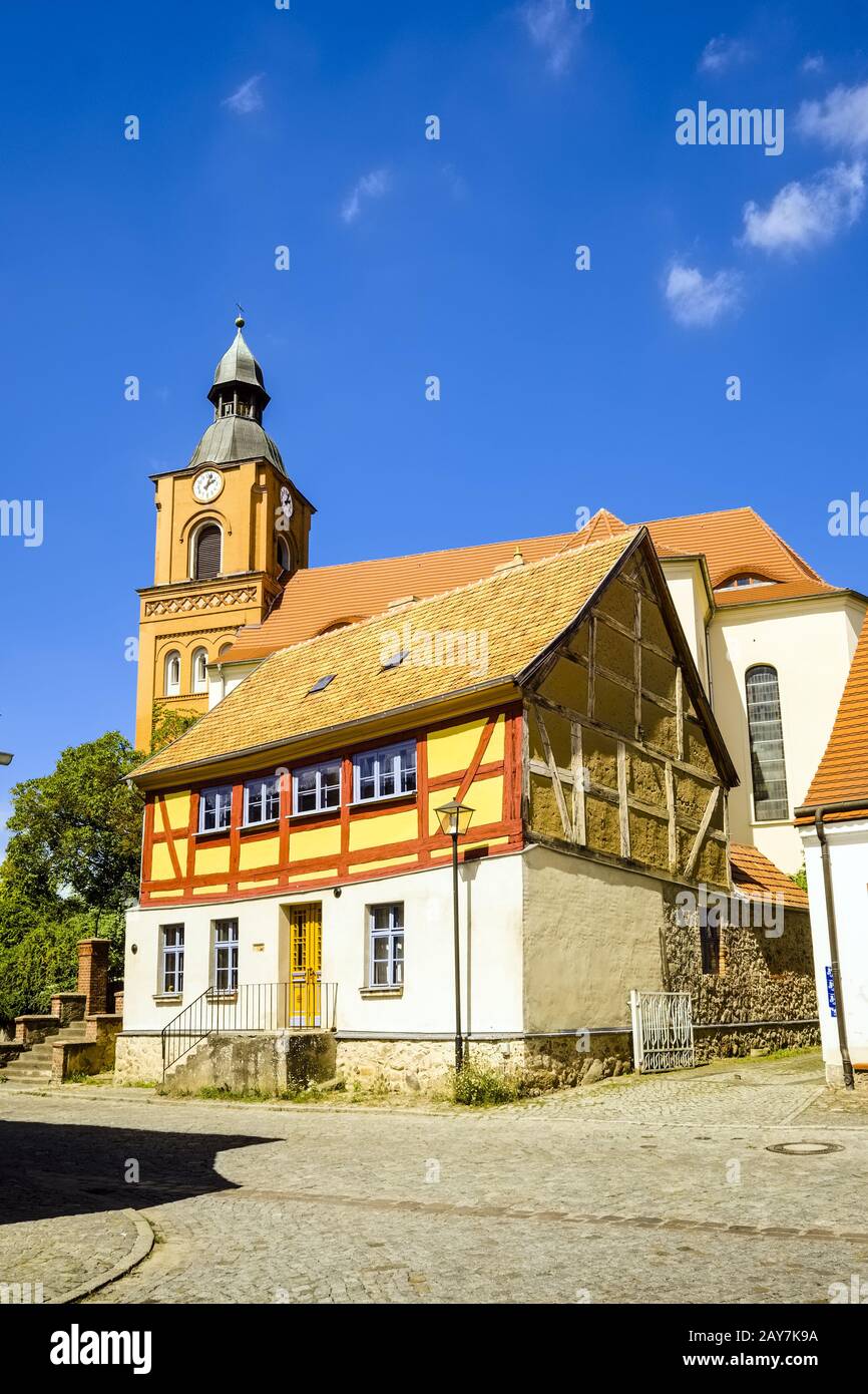 Half-timbered house in front of Parish church in Buckow, Brandenburg, Germany Stock Photo