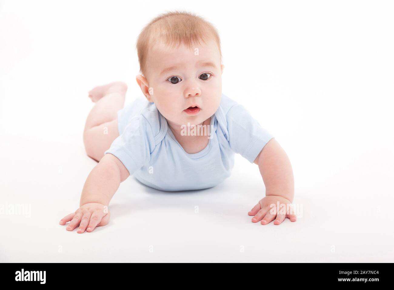 baby in the body lying on his stomach on a white background and Stock
