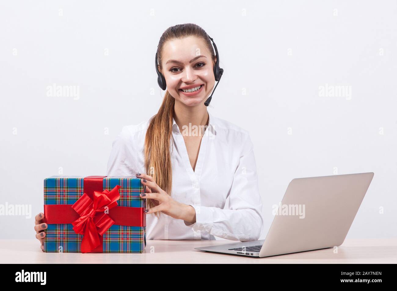 girl in a white blouse with a headset on his head sitting in fro Stock Photo