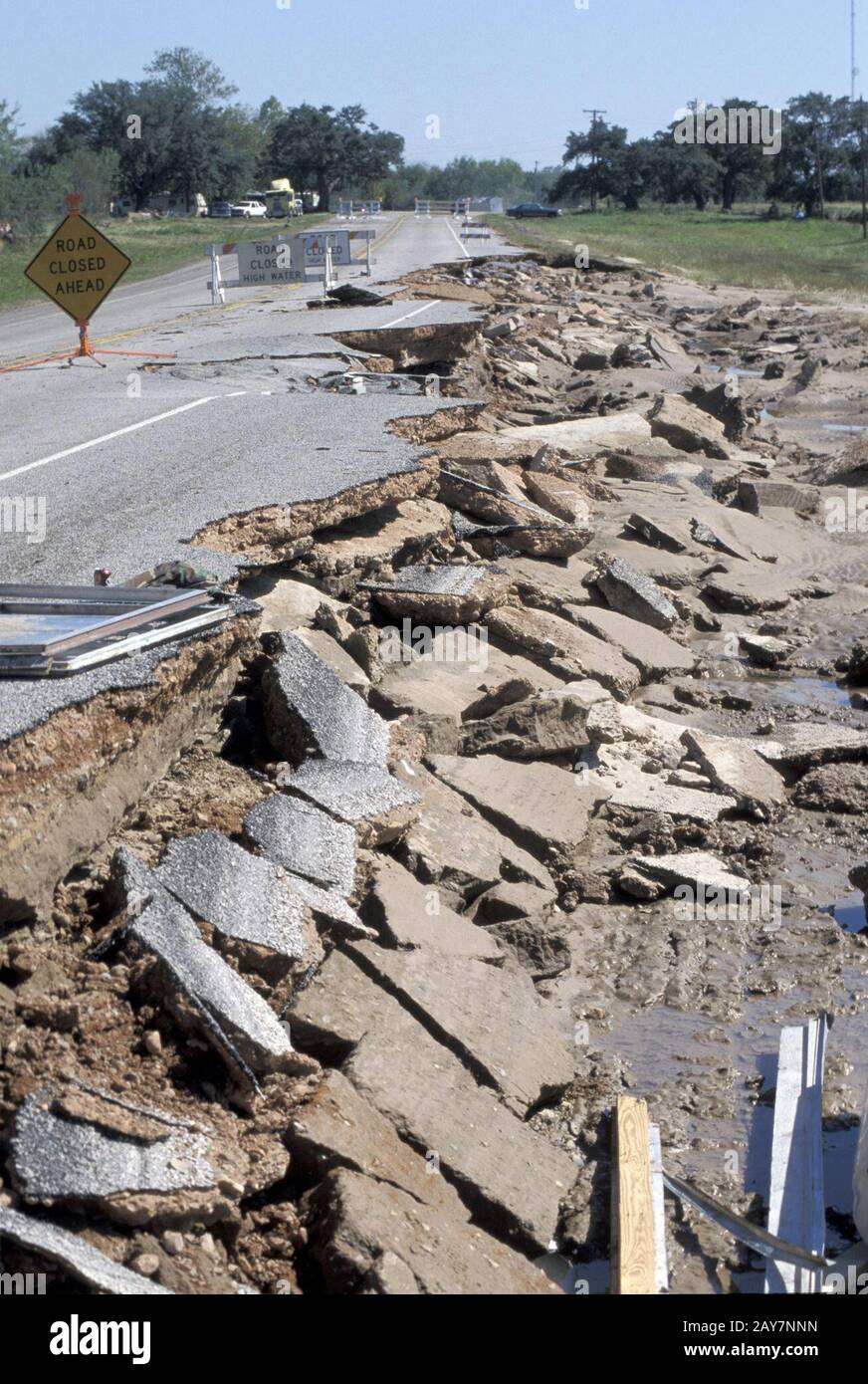 Cuero, Texas: Flood damage to road where pavement was ripped up by floodwaters on the Guadalupe River. 1998 ©Bob Daemmrich Stock Photo