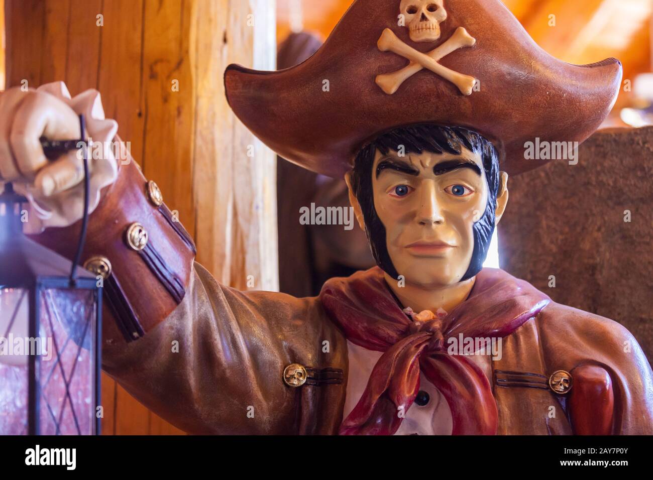 pirate with oil lamp at dinosaurs at Log Barn 1912  Throwback Roadside Attraction Stock Photo