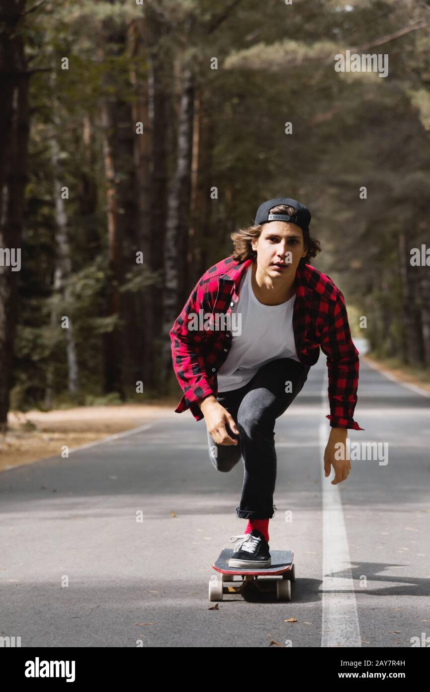 Adult youth man go speed on longboard skate on asphalt road. Mature people  enjoy outdoor leisure activity. Freedom and youthful lifestyle concept. Enj  Stock Photo - Alamy