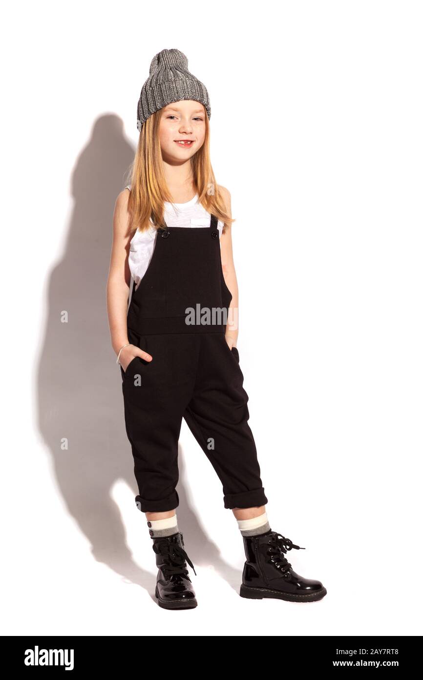 little girl in dark overall on the white background Stock Photo