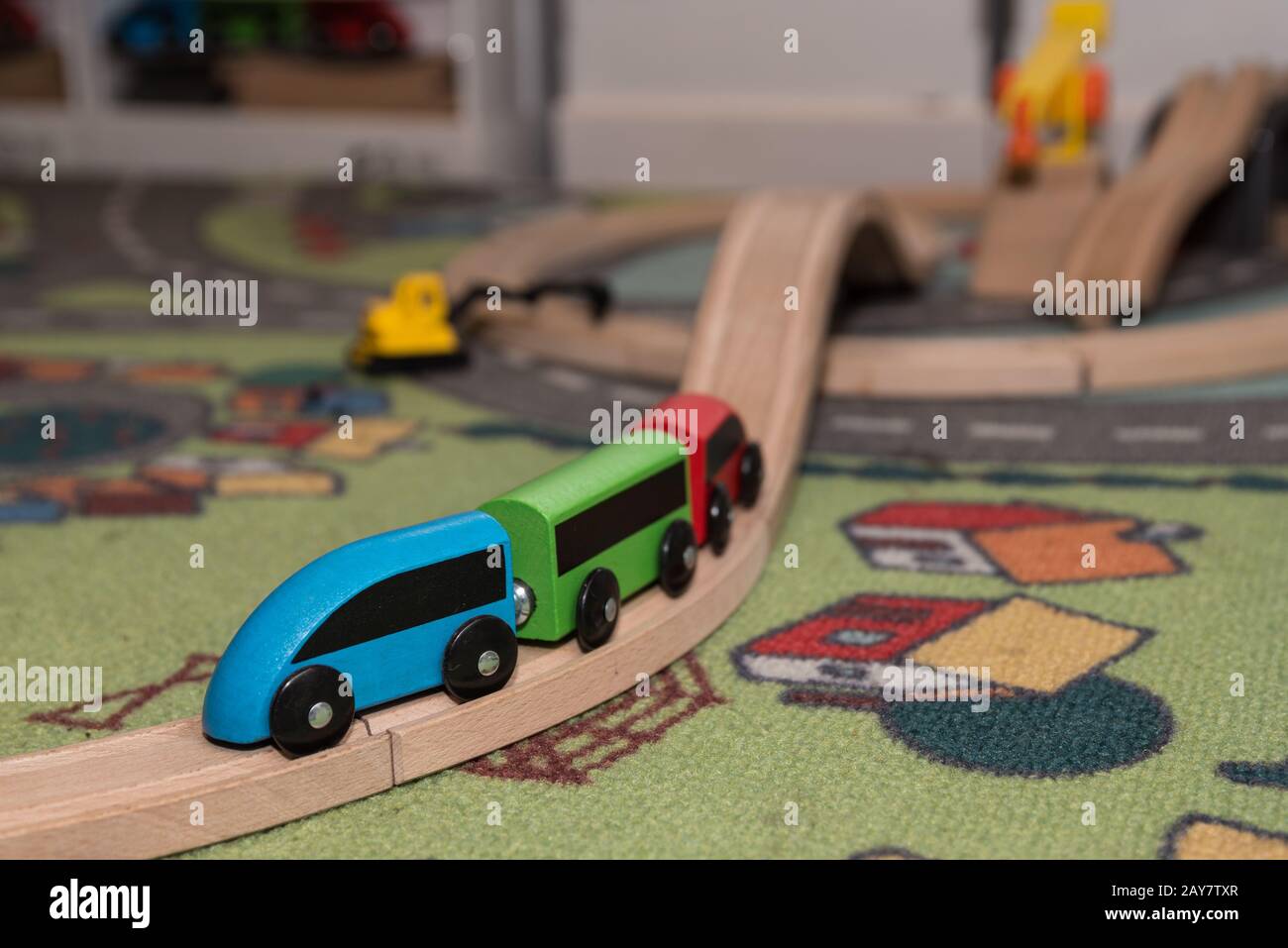 colourful wooden toy train with rails and toy carpet Stock Photo - Alamy