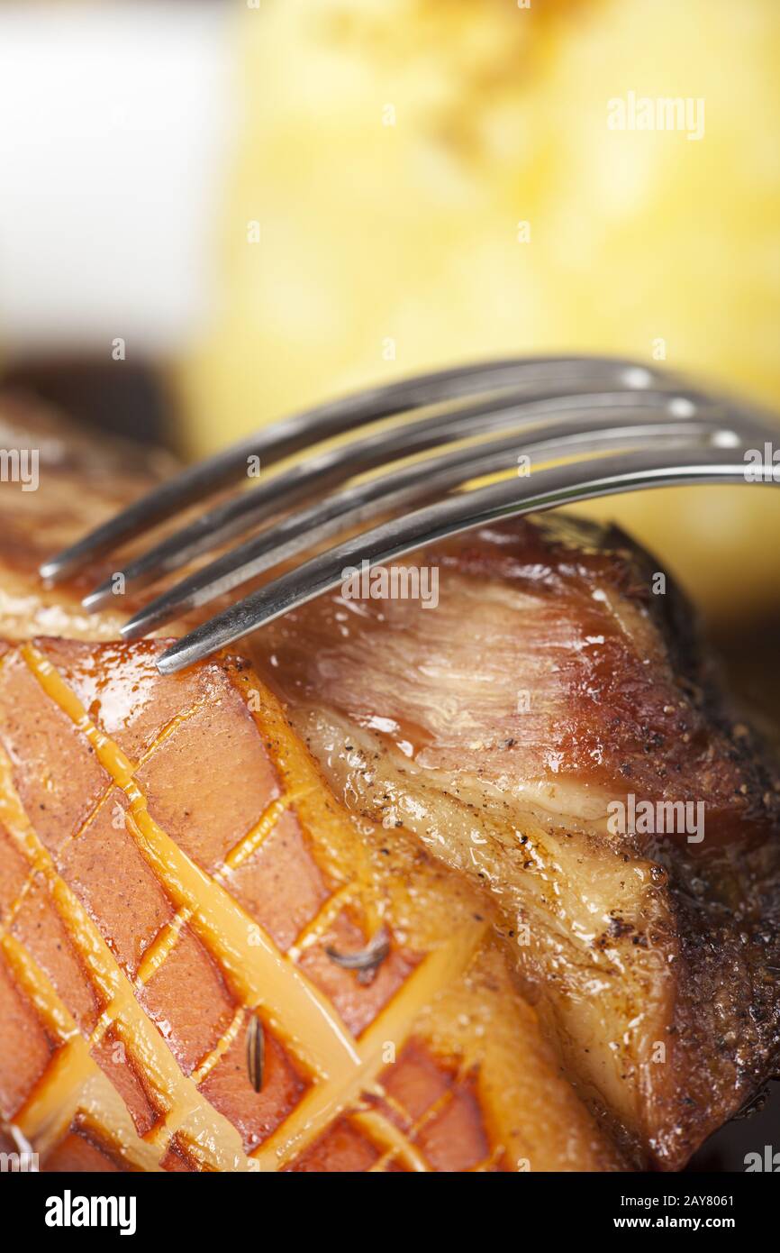 Fork on roast pork Stock Photo Alamy