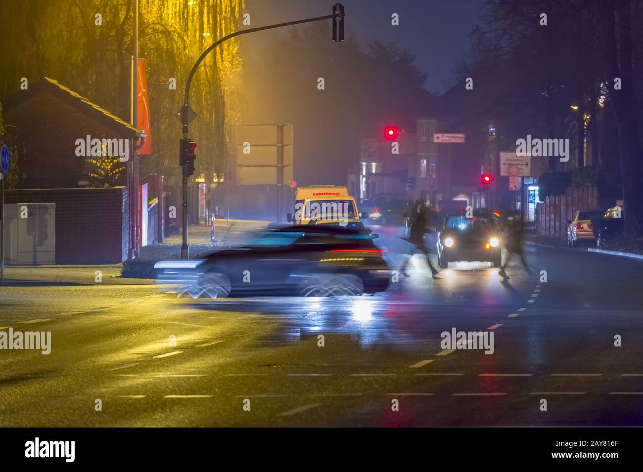 Road traffic on an intersection at night. Stock Photo