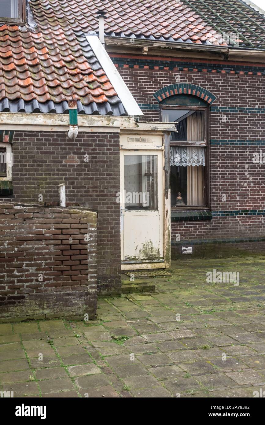 old Dutch abandoned and derelict house with backyard Stock Photo