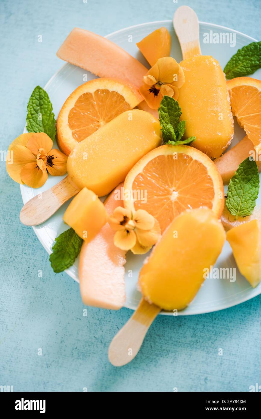 Homemade summer treat orange popsicles Stock Photo
