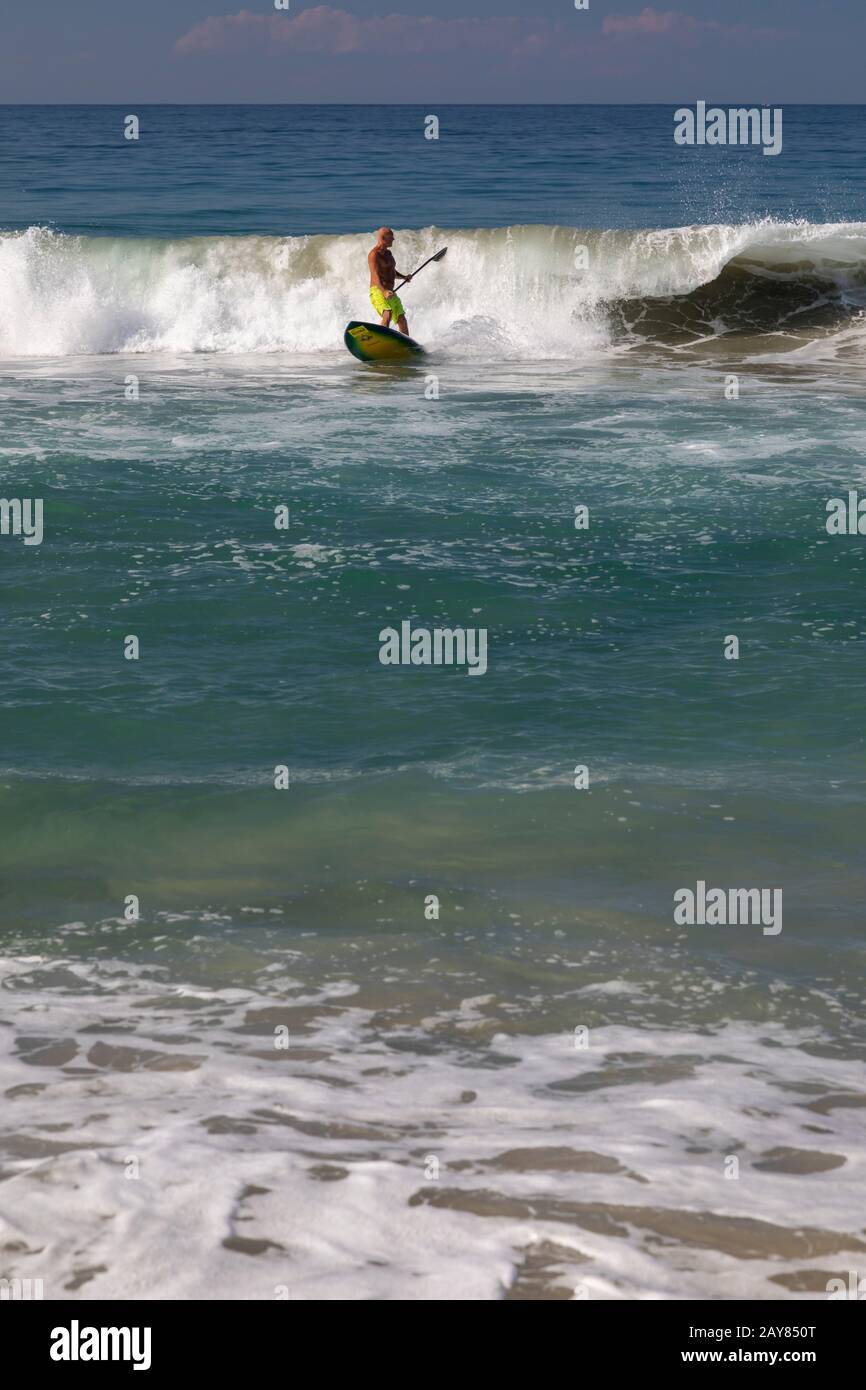 Brisas de Zicatela, Oaxaca, Mexico - A man paddles a surfboard on the Pacific Ocean. Stock Photo