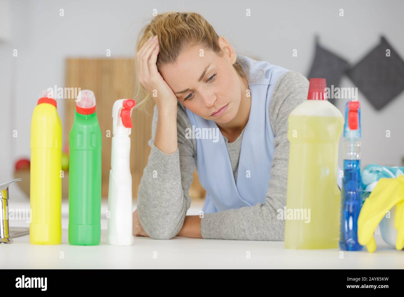 studio shot of middle aged woman holding cleaning products Stock Photo