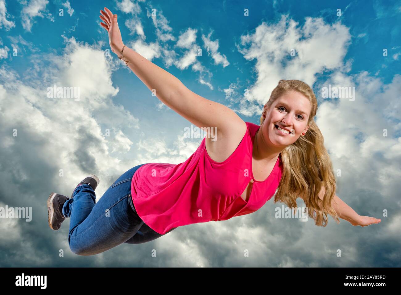 Happy girl jumping blue sky hi-res stock photography and images - Alamy