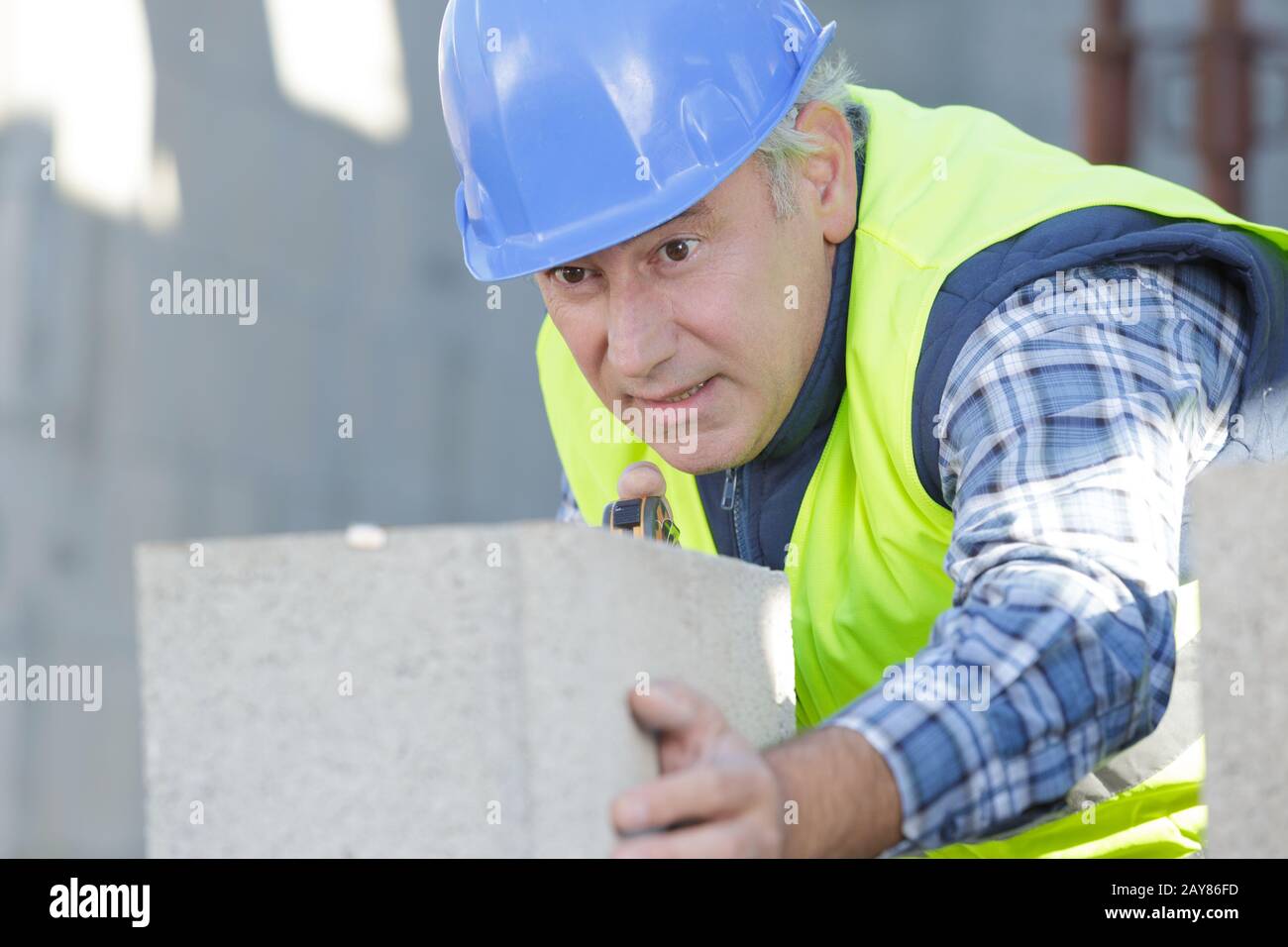 construction worker moving mixer in masonry site Stock Photo