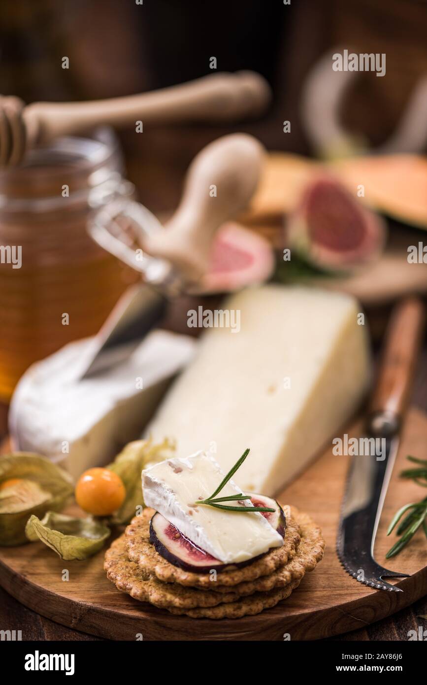 Cheese crackers with camembert,honey,fig and herb Stock Photo Alamy