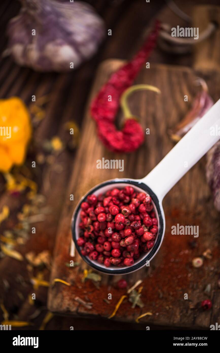 Red pepper whole seeds on spoon. Stock Photo