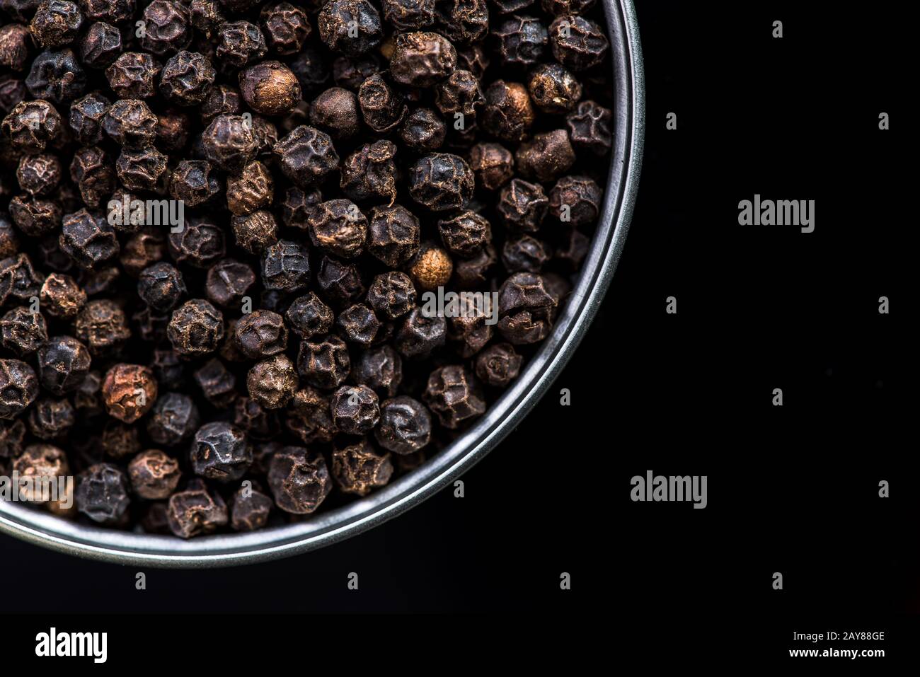 Black pepper seeds in pot with copy space Stock Photo Alamy