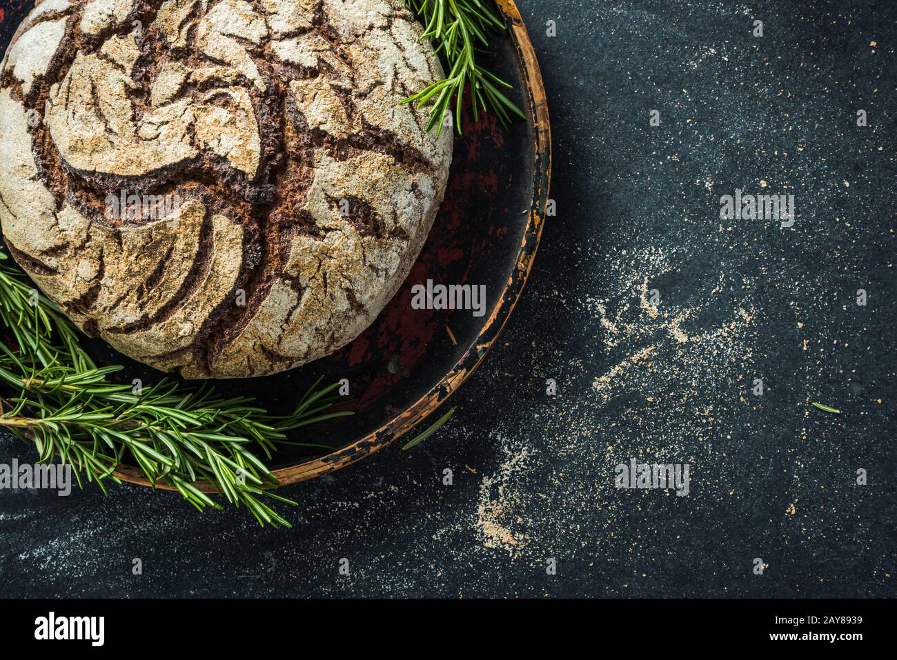 Rye bread loaf on dark slate Stock Photo