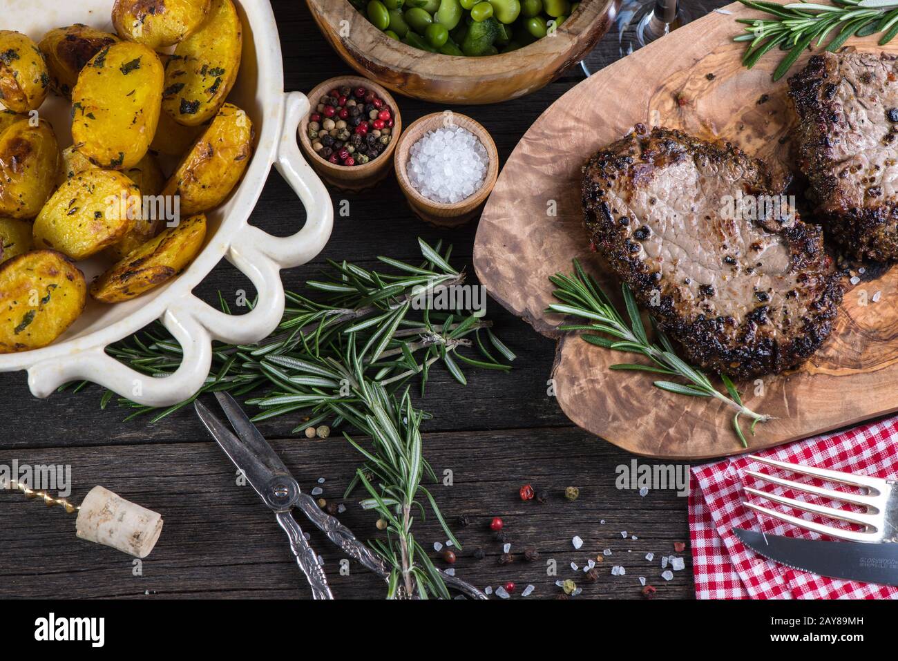 Grilled beef steak with fresh herbs and roasted potatoes Stock Photo