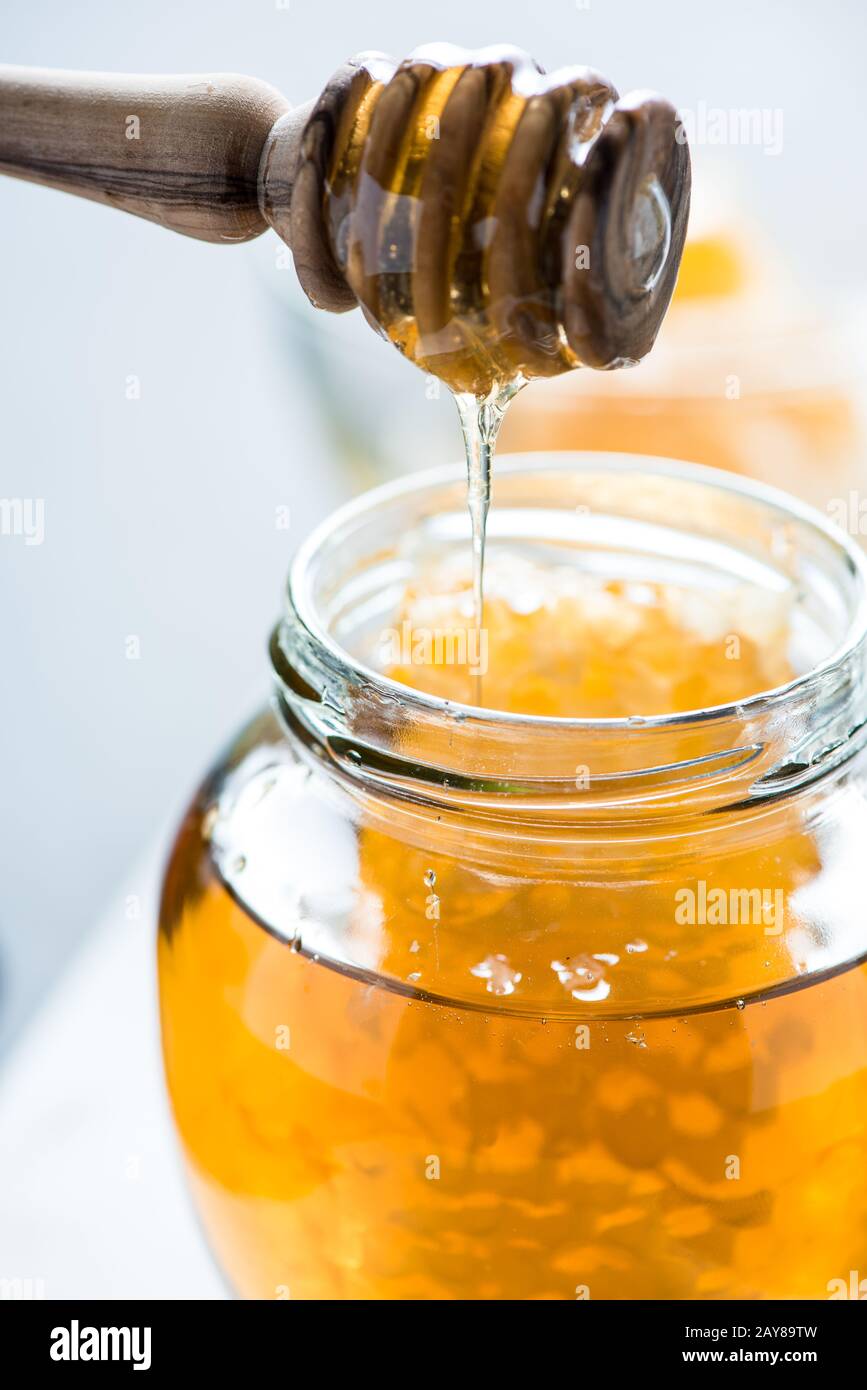 Dripping honey into jar Stock Photo Alamy
