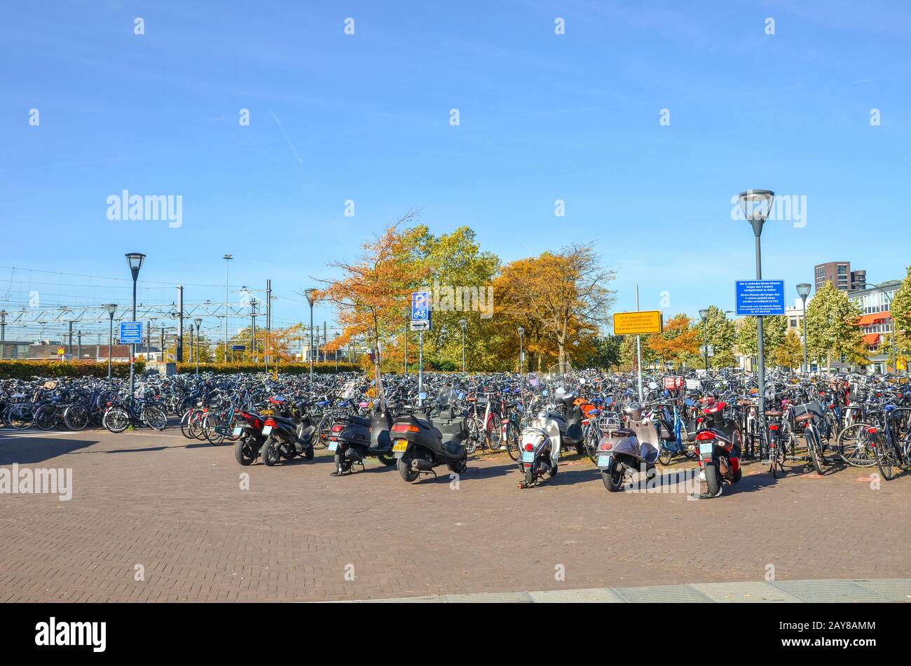 Venlo, Limburg, Netherlands - October 13, 2018: Rows of parked bicycles and motorcycles in the Dutch city close to the main train station. City biking. Eco-friendly means of transport. Stock Photo