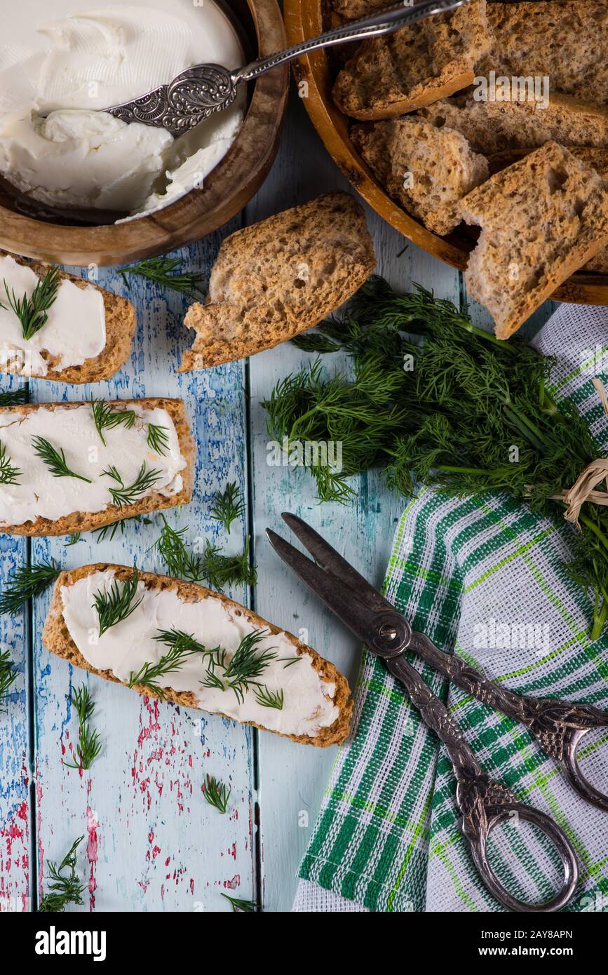 Spring freshly clipped dill with soft cheese Stock Photo