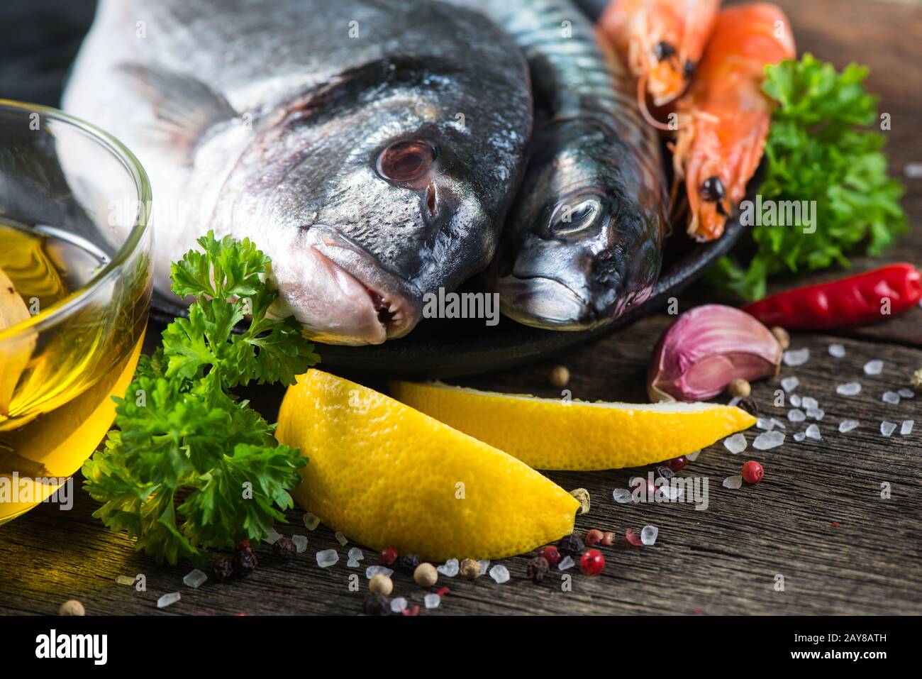 Fresh whole sea fish with aromatic herbs and spices Stock Photo