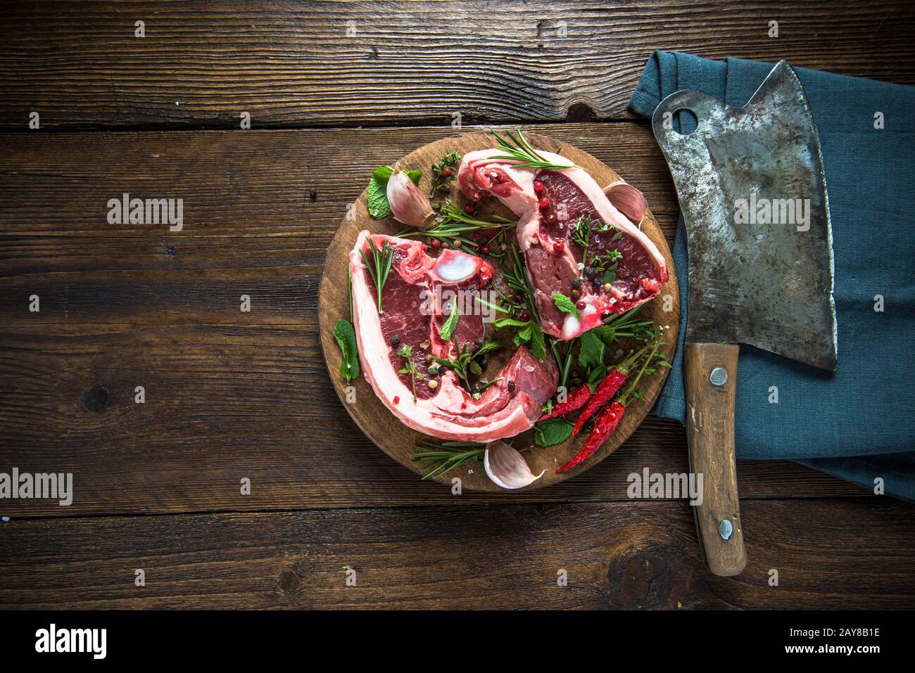 Lamb chops with seasoning on cutting board Stock Photo
