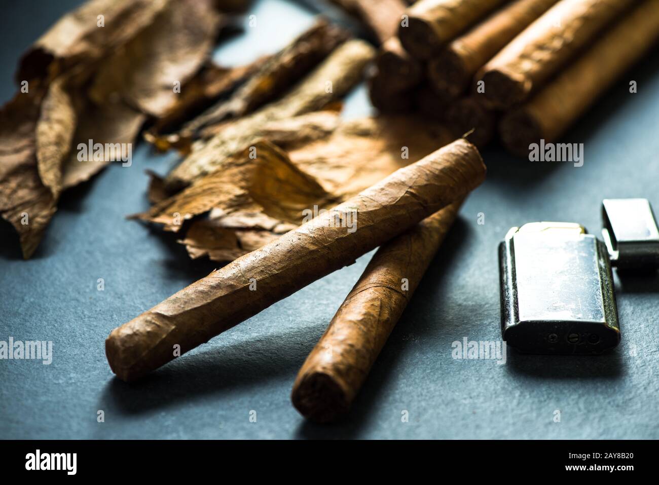 Cuban cigars with leafs and lighter Stock Photo
