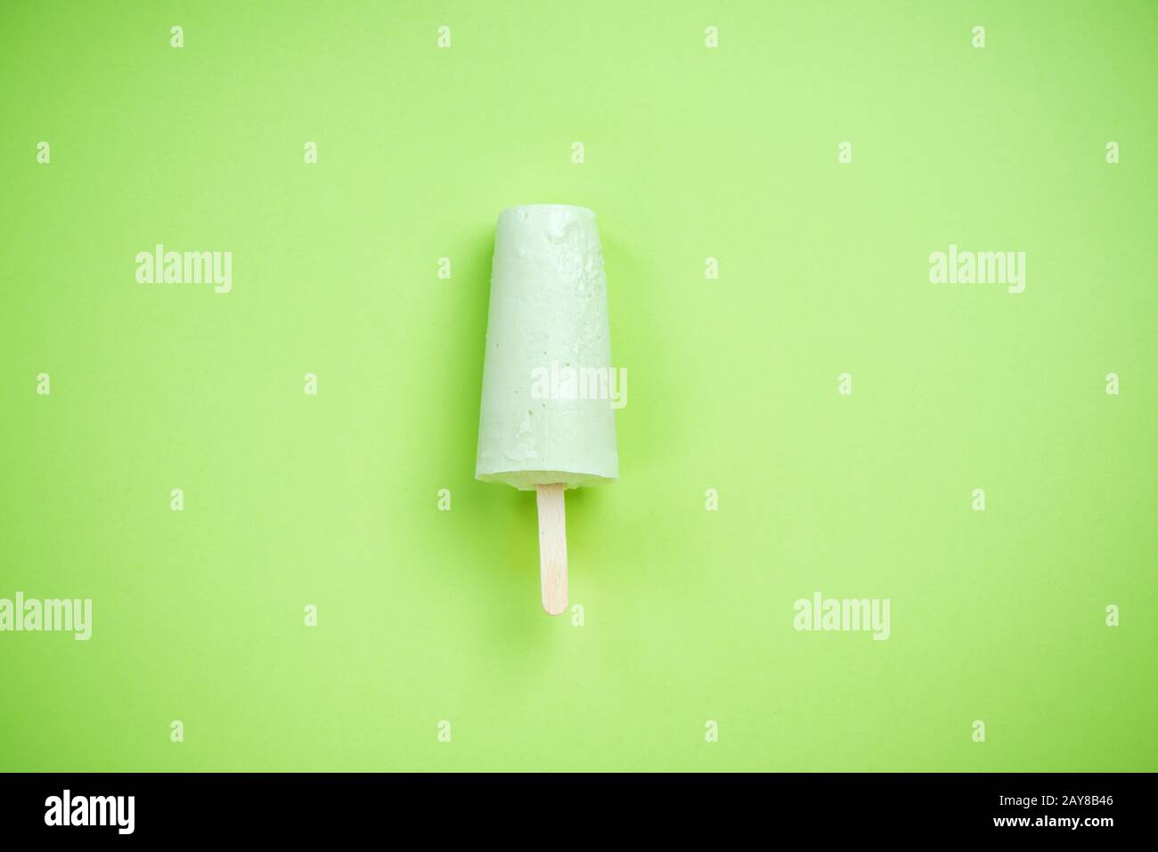 Green popsicle on green pastel background Stock Photo