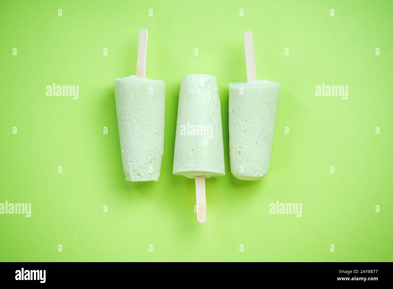 Green popsicles on green pastel background Stock Photo