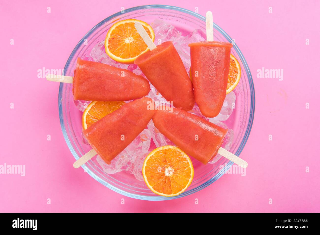 Orange juice healthy popsicles over ice cubes Stock Photo