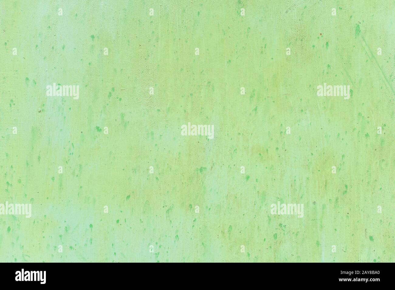 Textured metal surface carelessly colored green paint and faded in the