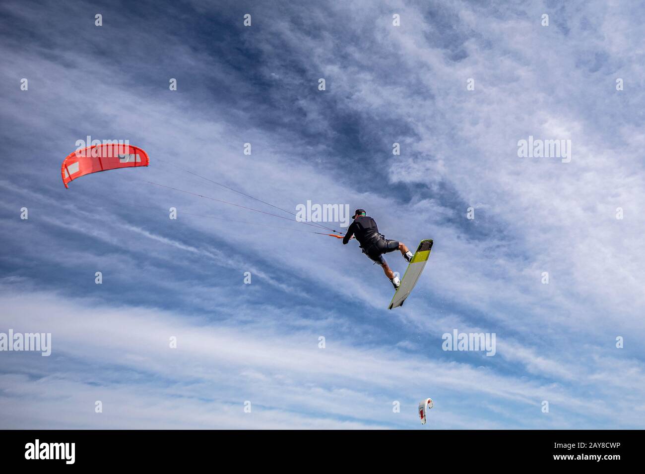 Retirement age male kitesurfer performing a kite loop or mega loop