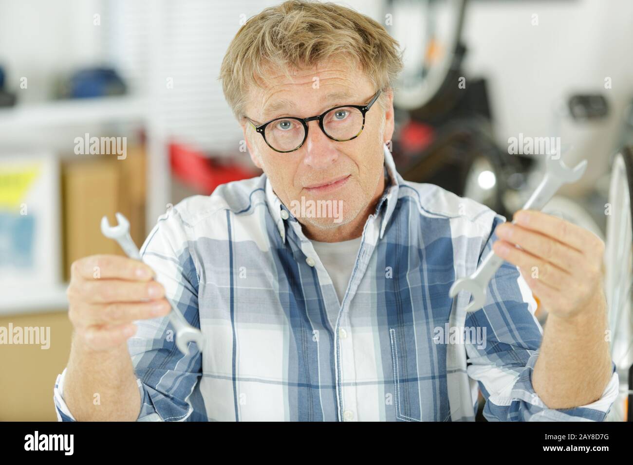 annoyed tradesman looking for a lost tool Stock Photo - Alamy