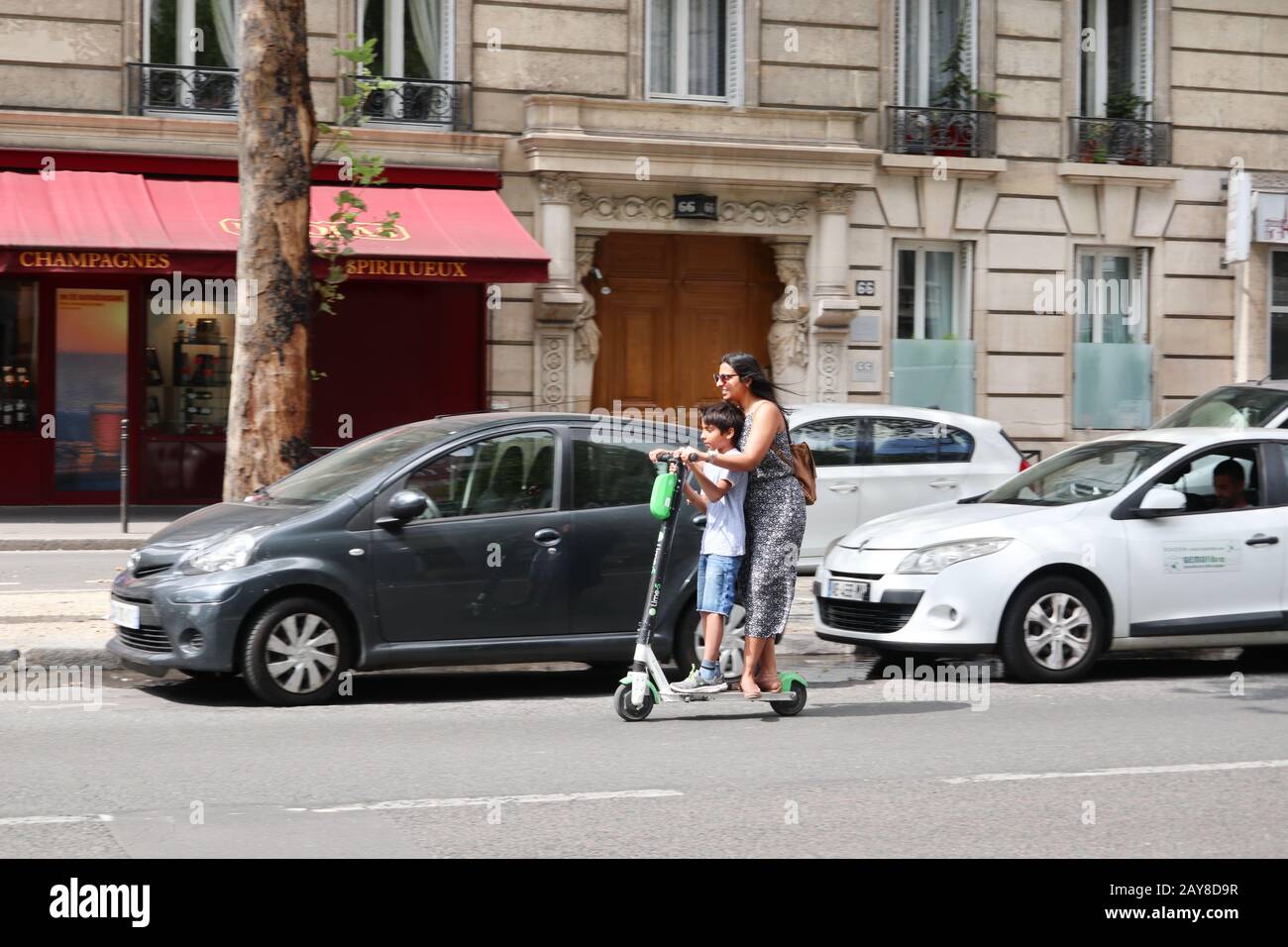 Woman and child Ride electric scooter in Paris, France Europe Stock Photo