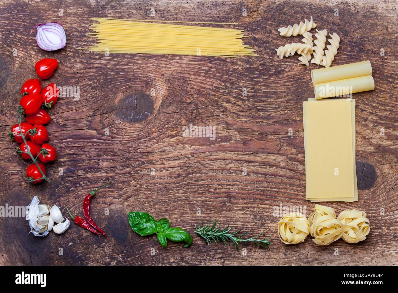 Frame of pasta and ingredients on wood Stock Photo - Alamy