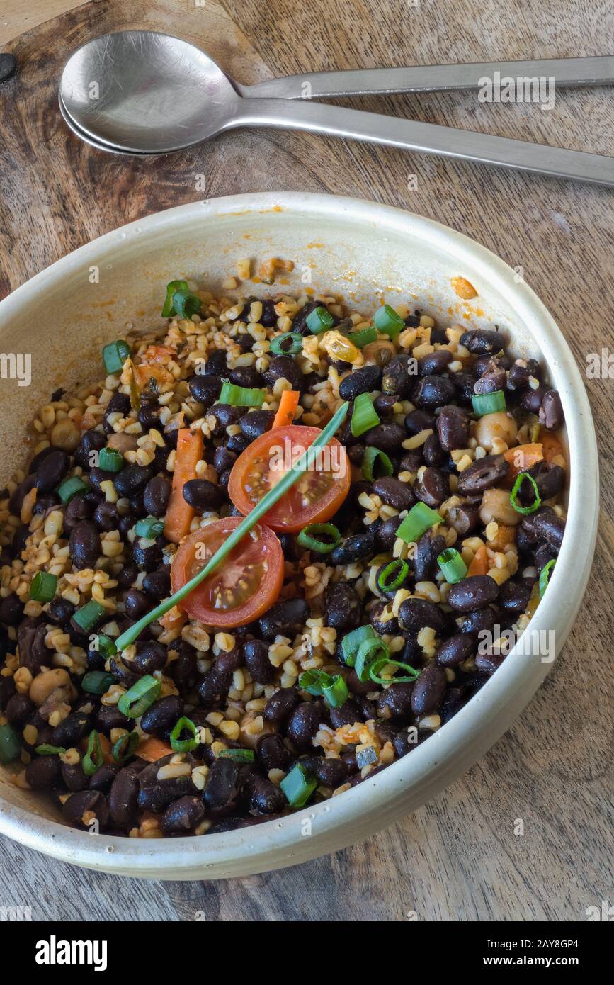 Savoury bulgur salad with black beans Stock Photo Alamy