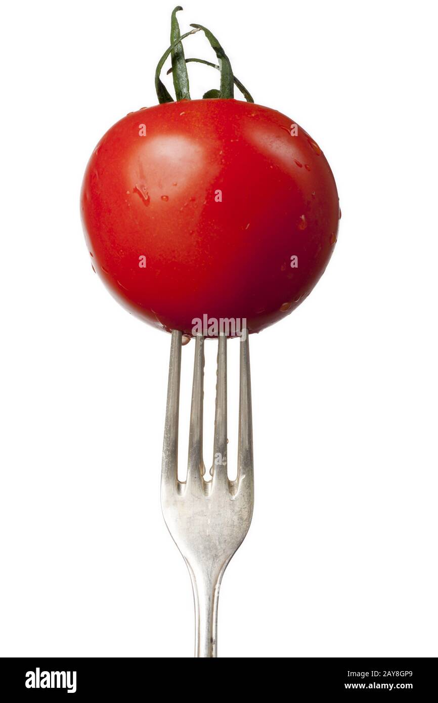 fresh tomato on an old silver fork Stock Photo