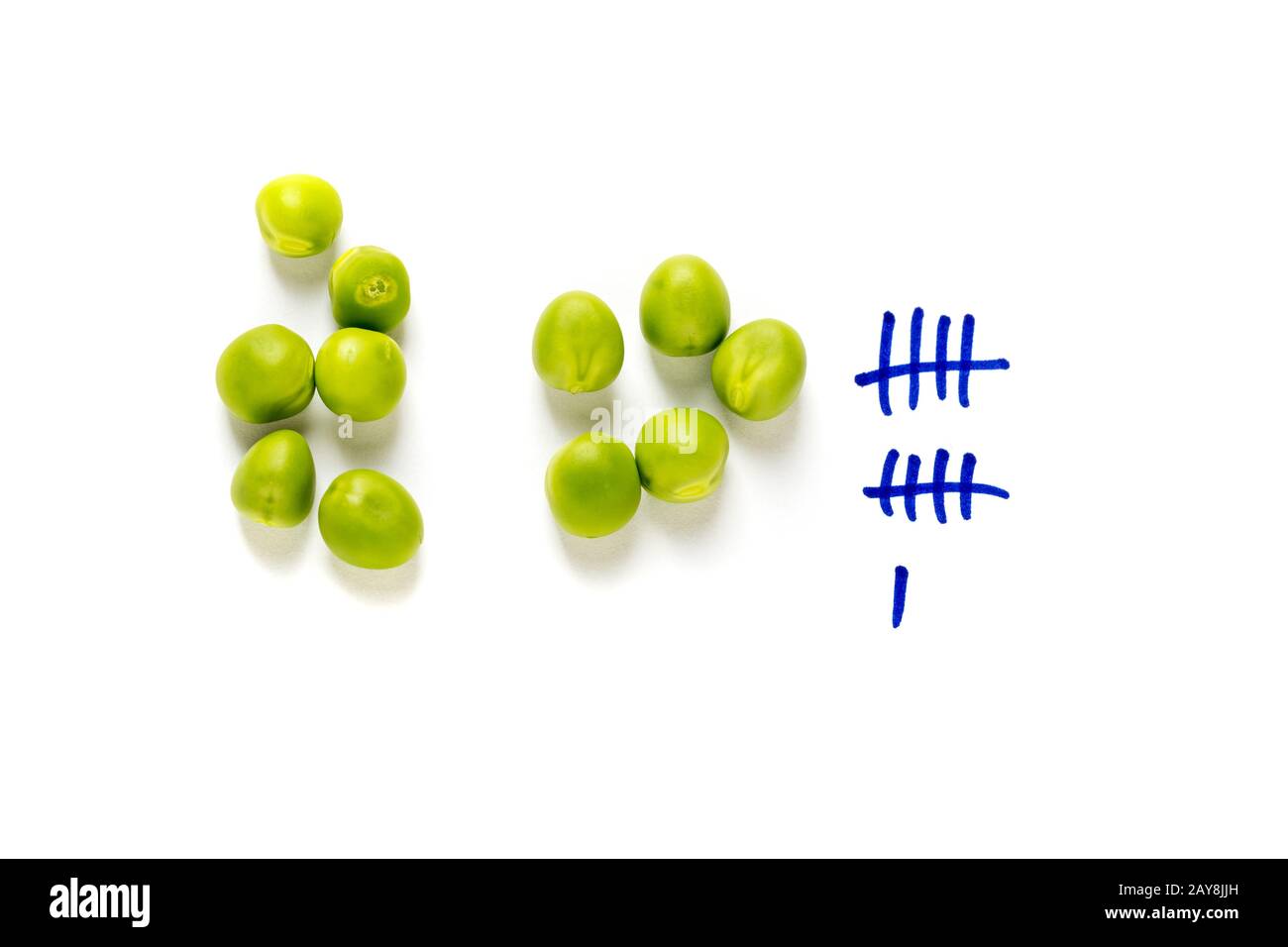 Counting peas on white background Stock Photo