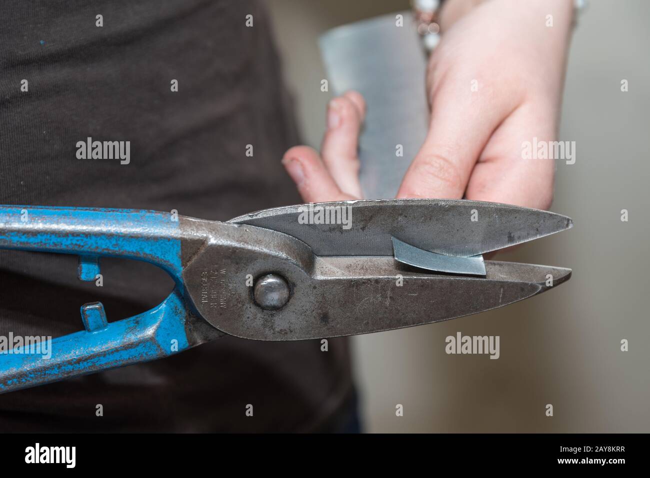 Craftsman in the metal industry working with sheet metal shears - close-up Stock Photo