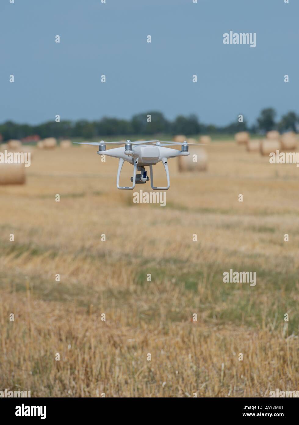 Drone flight over a straw round ball field Stock Photo