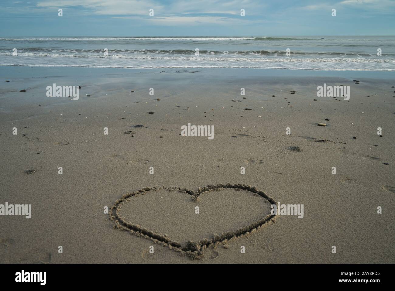 A heart painted in the sand on the beach in Panama and in the background the sea and the horizon Stock Photo