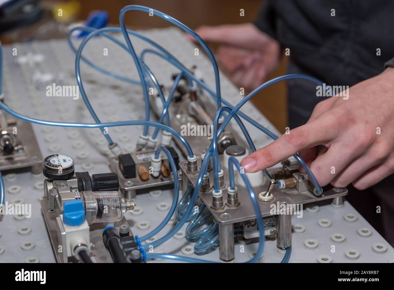 Using pneumatics on a machine at the push of a button - close-up Stock Photo