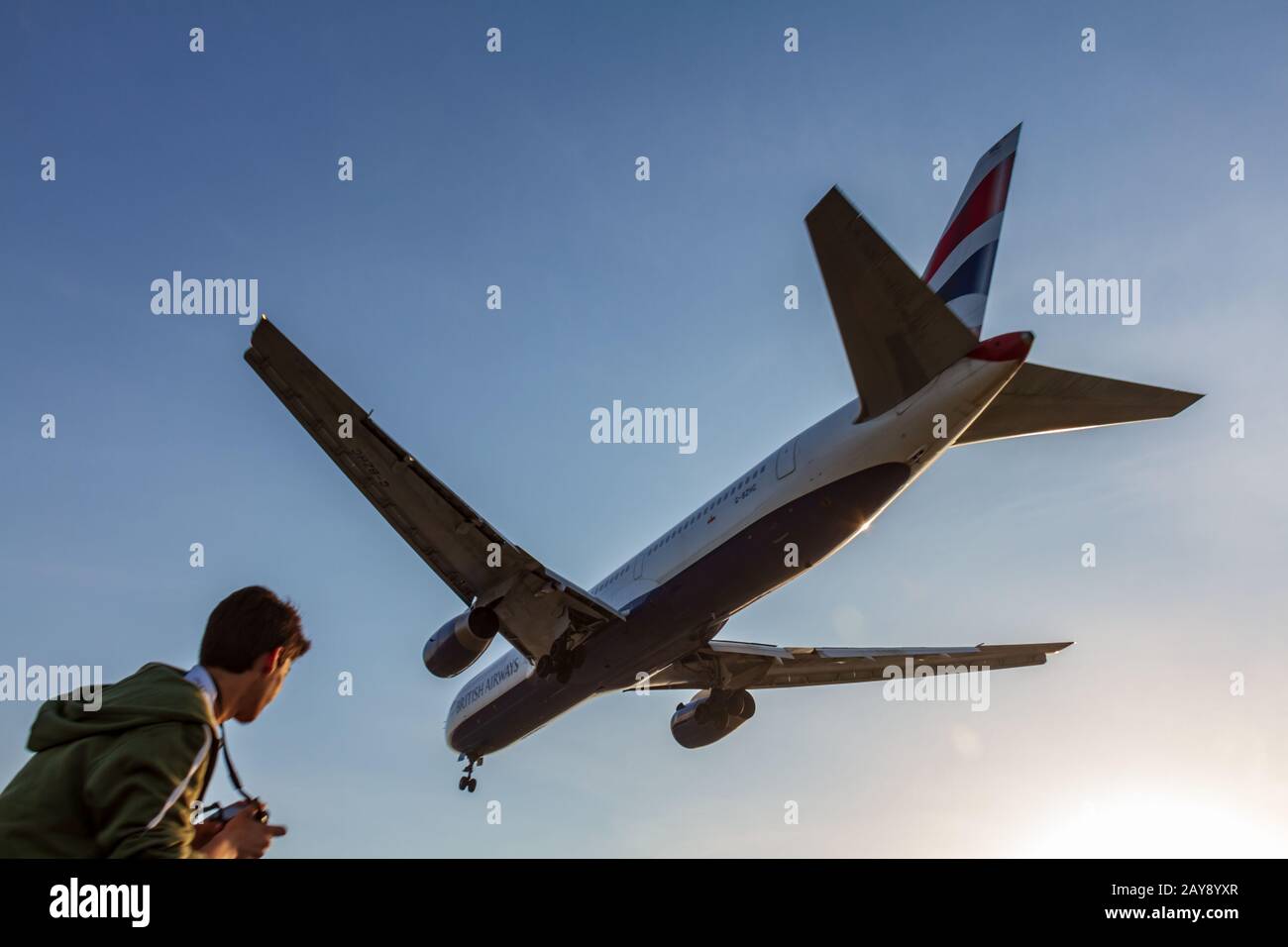 British Airways Boeing 767 moments before landing at Larnaca International Airport being watched by young photographer Stock Photo