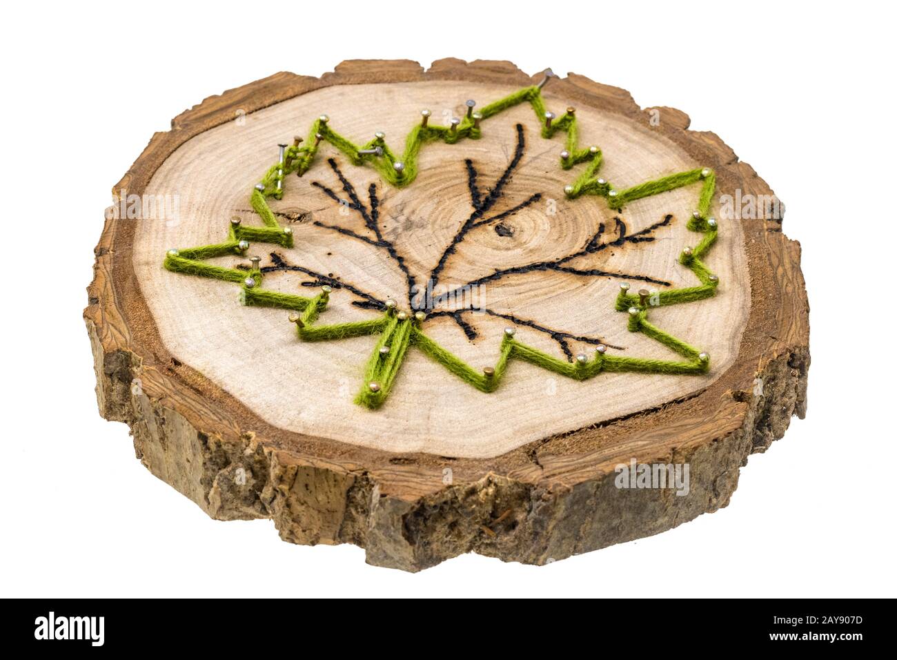 Maple leaf made of wool and nails on a tree slice with pyrography ...