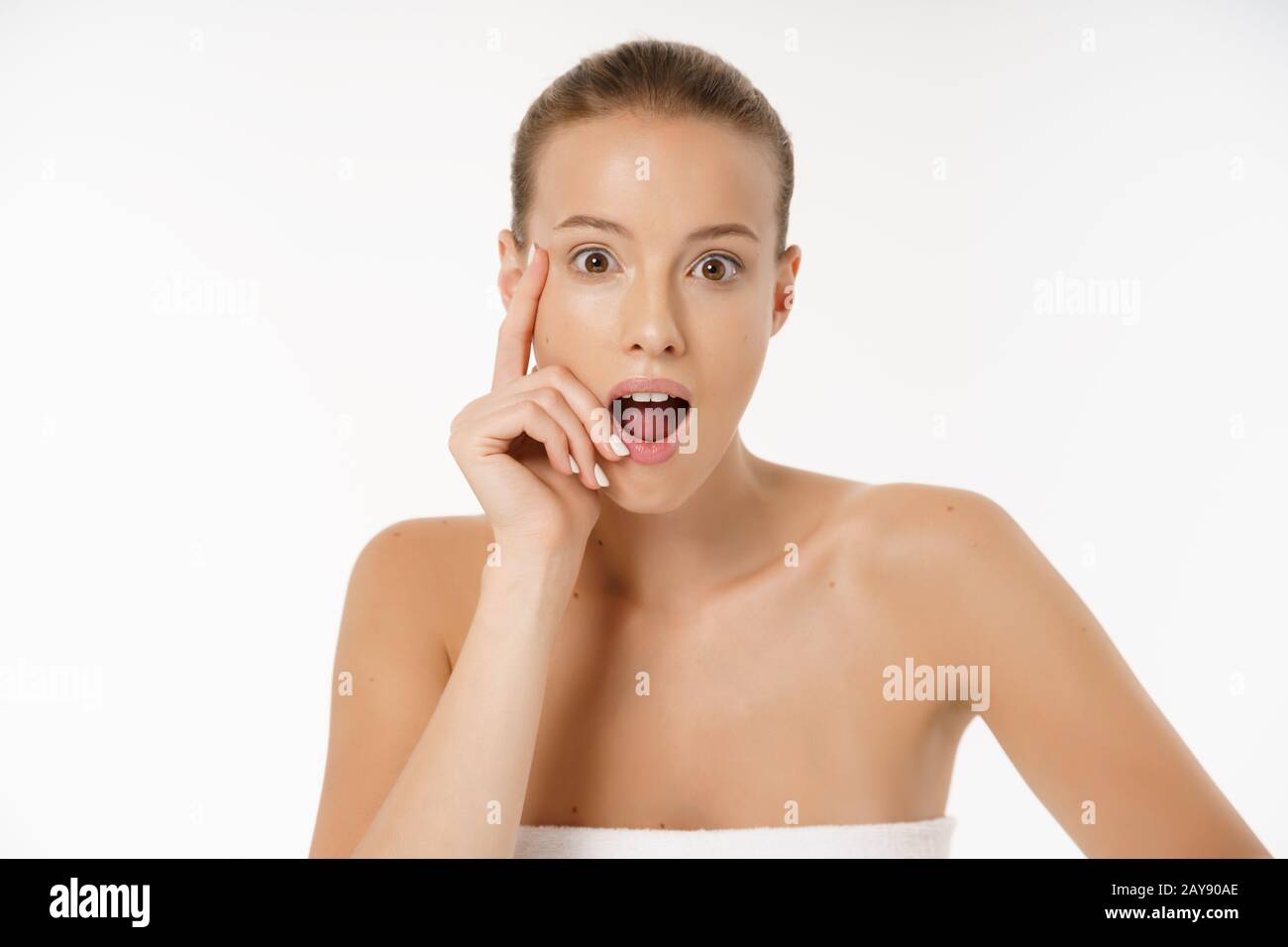 Close-up Of Worried Woman Looking At Pimple On Face Stock Photo