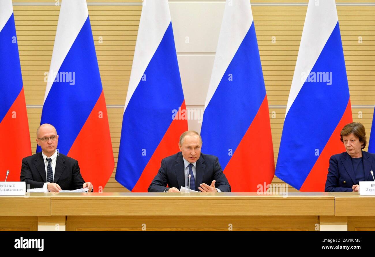 Russian President Vladimir Putin, center, chairs a working group on drafting proposals for amendments to the Constitution at the presidential residence of Novo-Ogaryovo February 13, 2020 outside Moscow, Russia. Sitting with Putin are: First Deputy Chief of Staff of the Presidential Executive Office Sergei Kiriyenko, left, and Aide to the President, head of the Presidential State-Legal Directorate Larisa Brychyova, right. Stock Photo