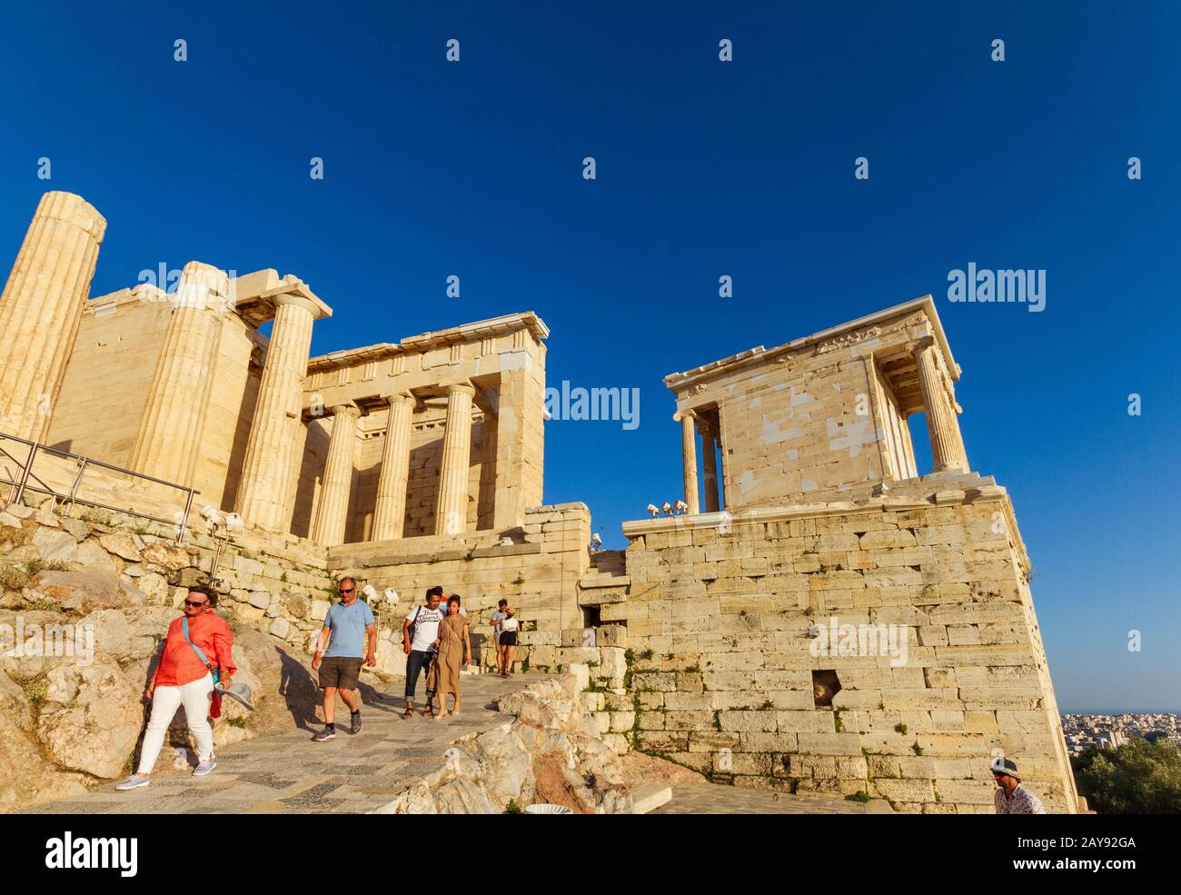 Tourists decendig the Propylaea, Ancient principal entryway to the Acropolis on a summer afternoon Stock Photo