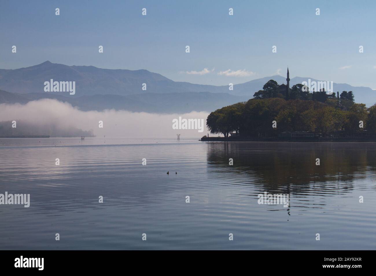 Aslan Pasha mosque on misty morning on Ioannina lake, Greece Stock Photo