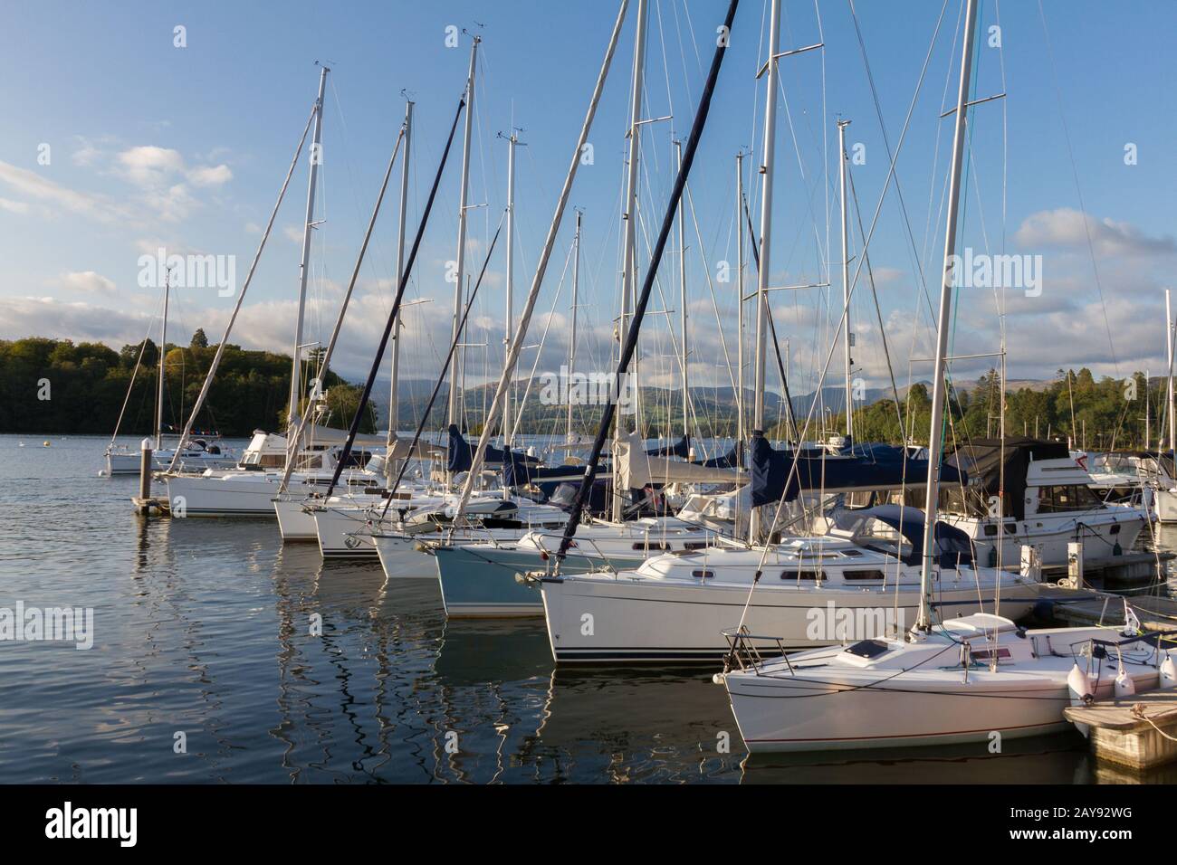 Luxury Sail Yachts moored along a Pier  in Bowness-on-Windermere on Lake WIndermere in Cumbria Stock Photo