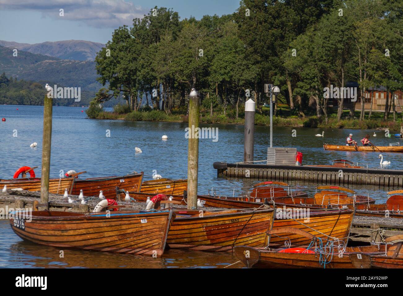 Piers and boats on edge of Bowness-on-Windermere in Lake District in Cumbria, United Kingdom Stock Photo